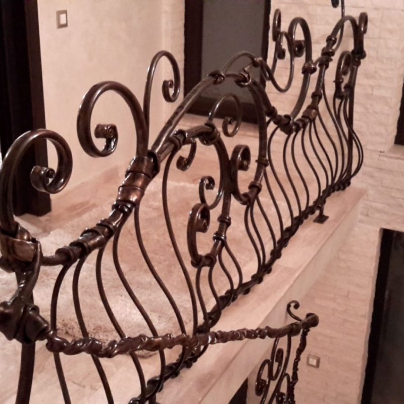 Forged metal interior railing — rhythmic vertical composition